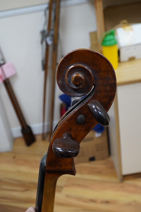A cased late 19th century German? cello, body length 75cm, together with two bows. Condition - fair to good.